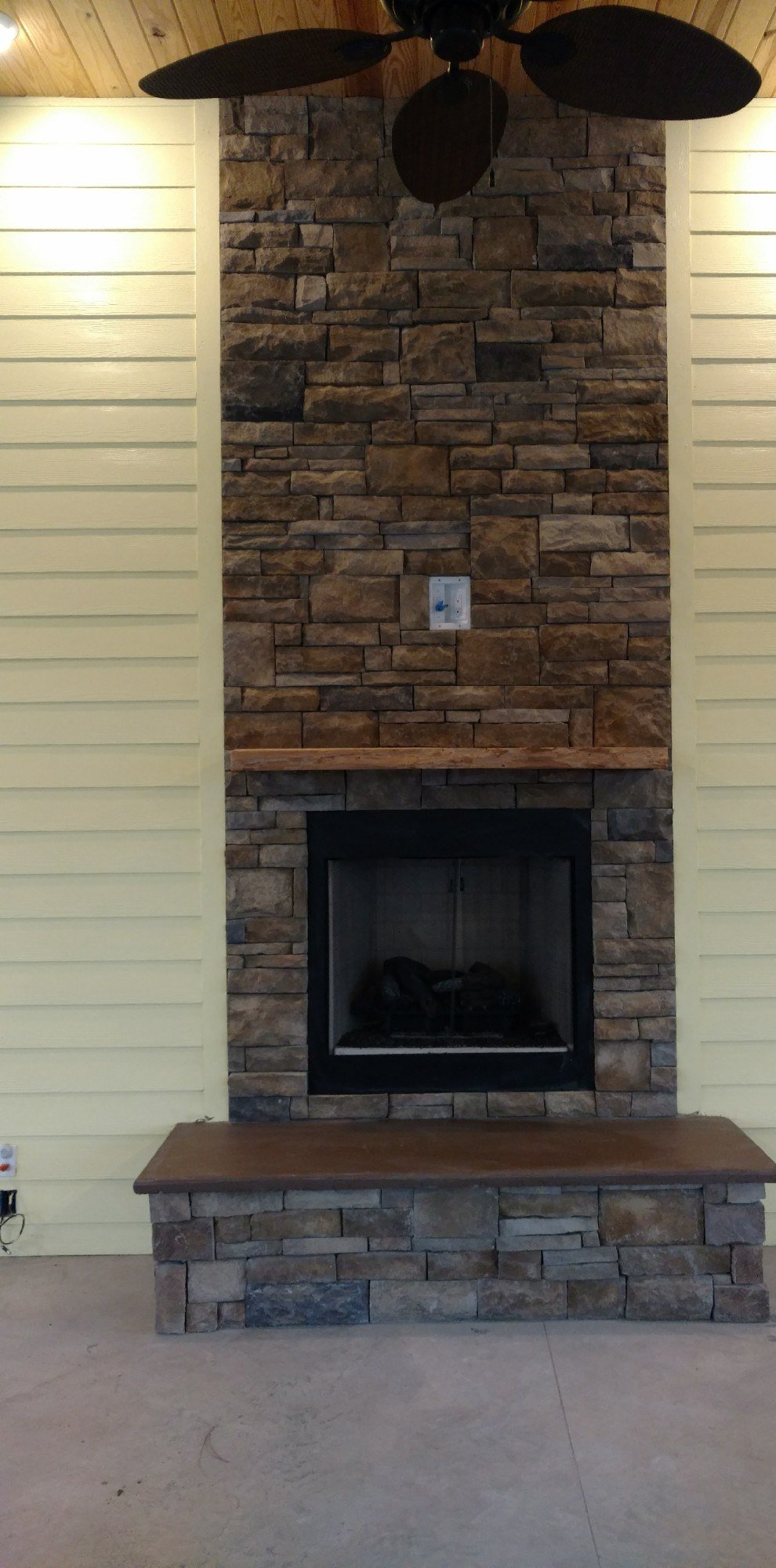 Finished outdoor stone fireplace