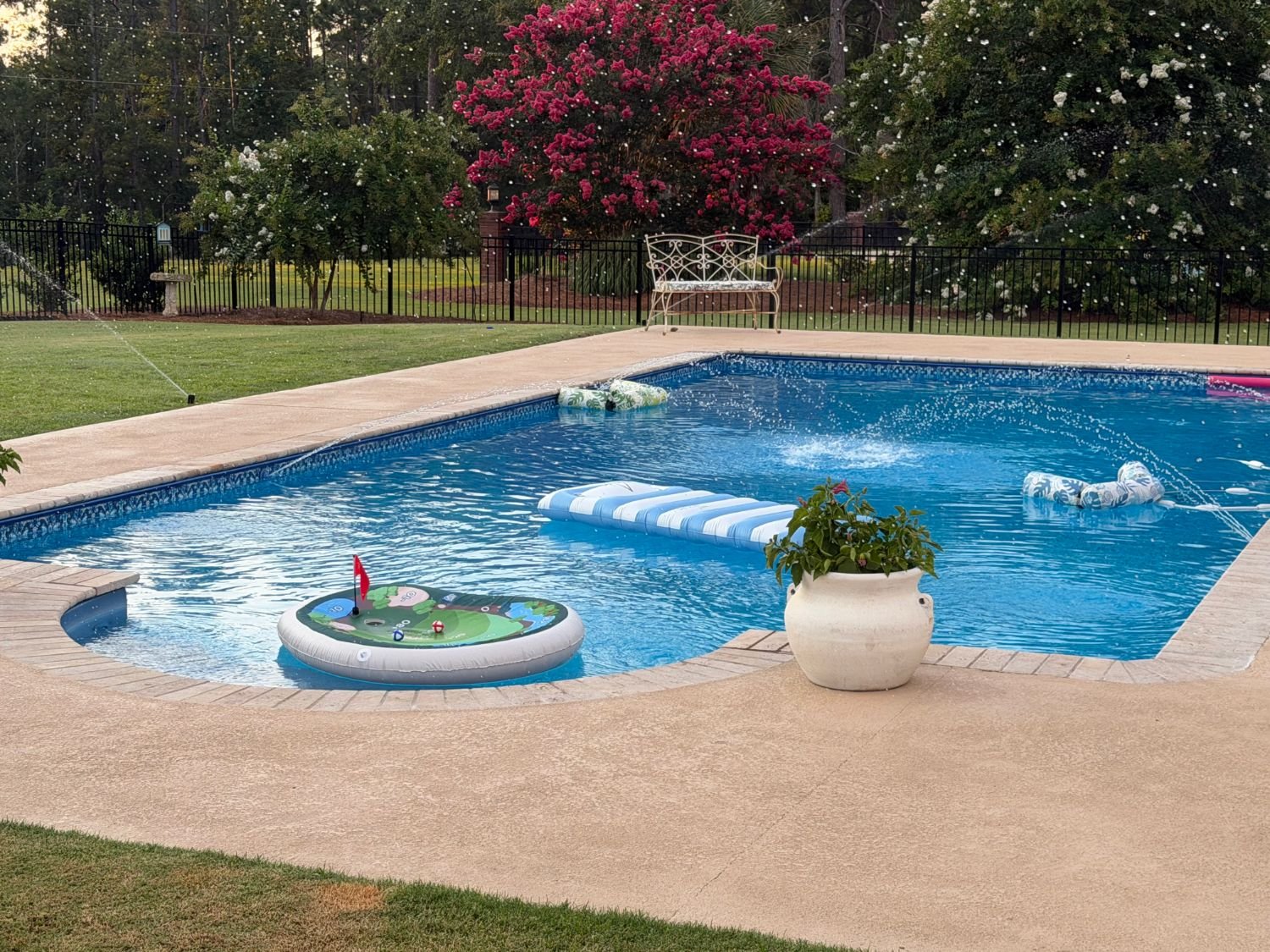 Finished pool with loungers and evening lighting
