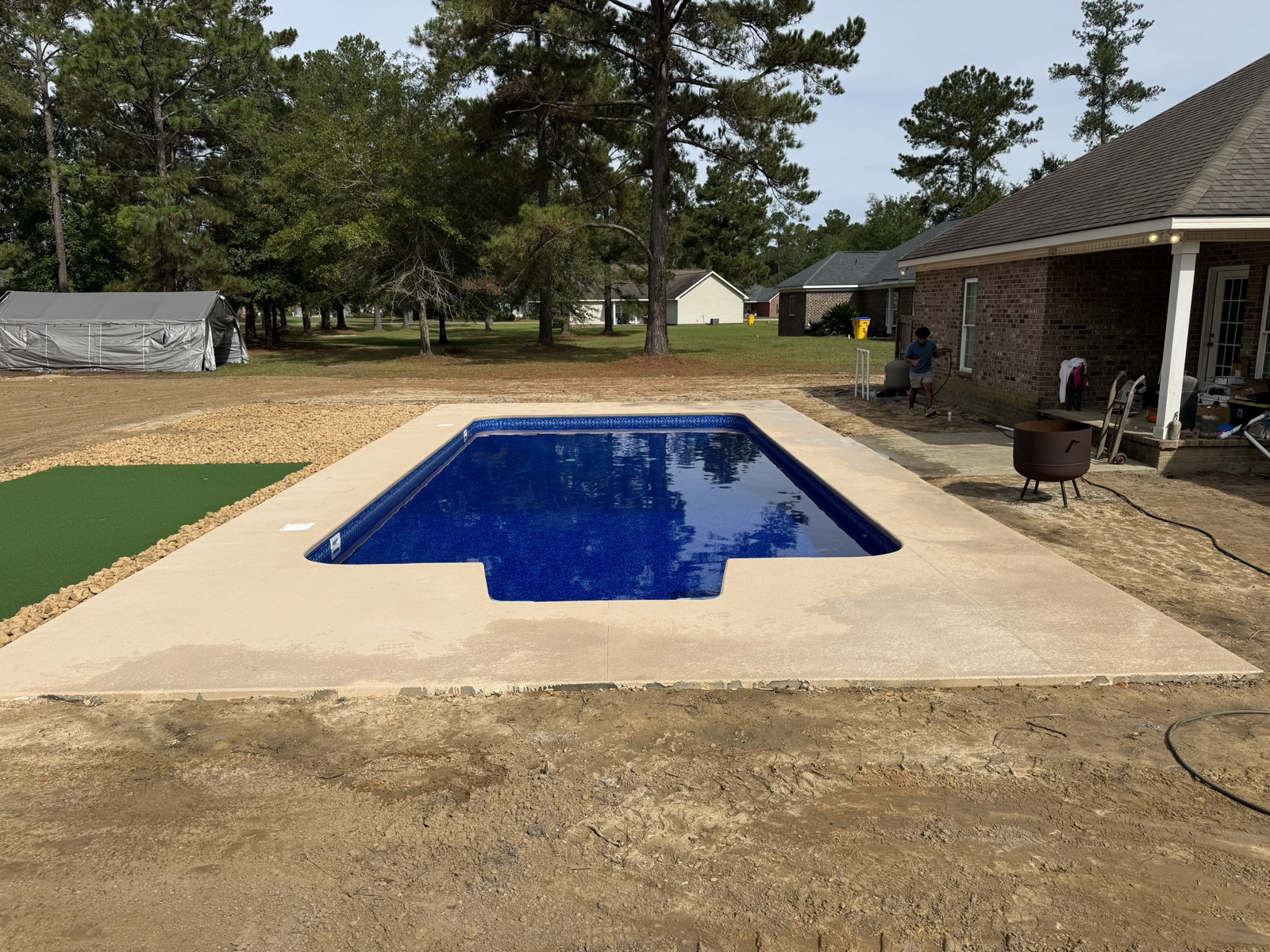 18x36 vinyl liner pool with a McEwen liner and deck beside the custom putting green